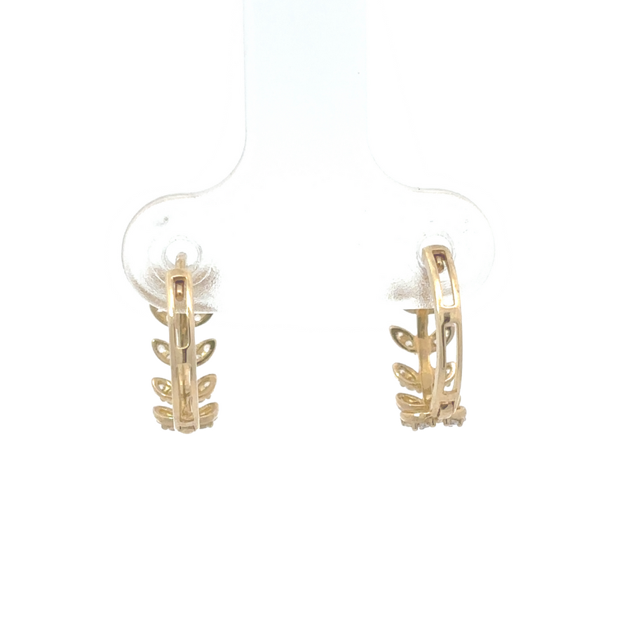 10K gold earrings on a delicate baby-sized ear, showing a secure and gentle fit