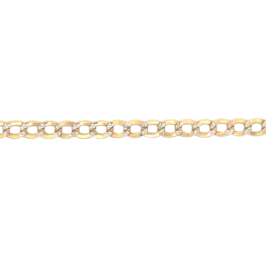 10k Cuban chain layered with other gold chains on male model