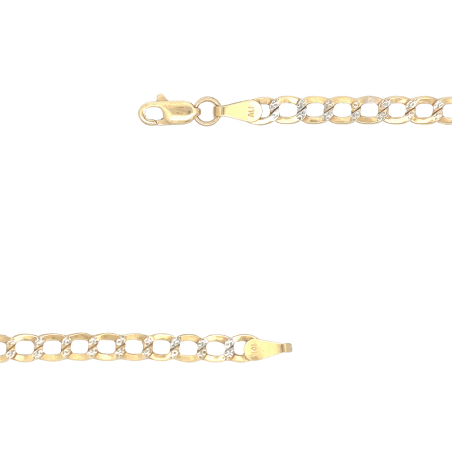 The 10k gold Cuban chain displayed against a dark background, highlighting its brilliance and bold design