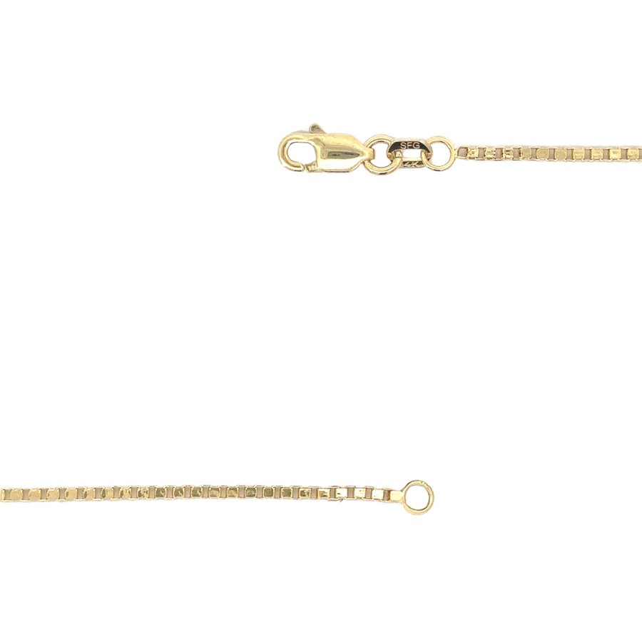 21-inch gold chain layered with other necklaces on a woman