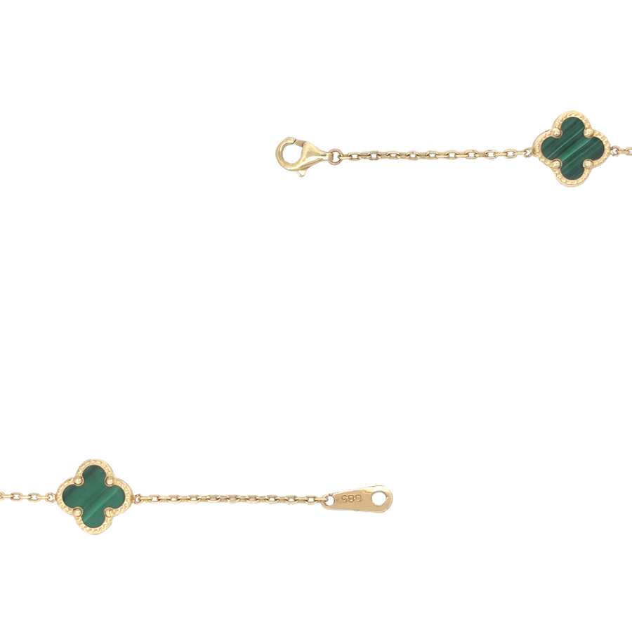 Model wearing 14K gold necklace with green flower accents, showcasing the 27.5-inch length