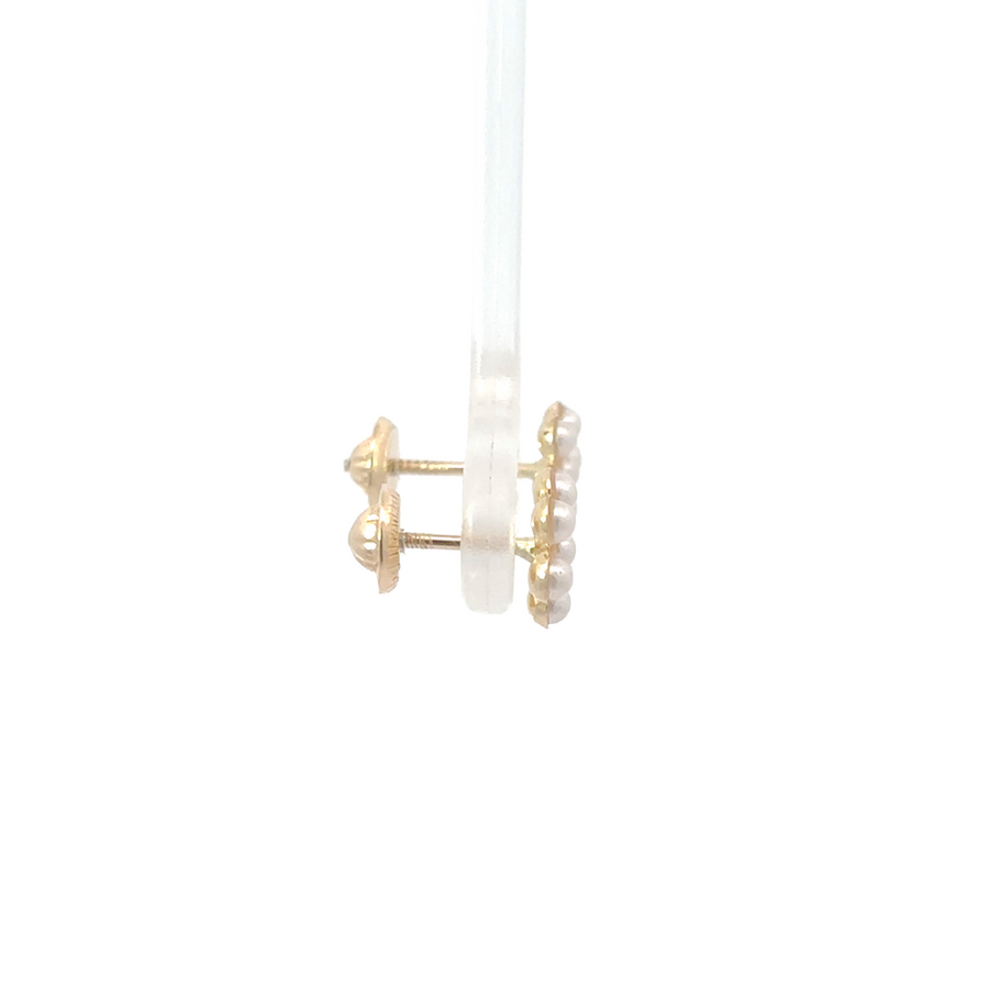 Side view of 14K gold floral stud earrings with lustrous pearl