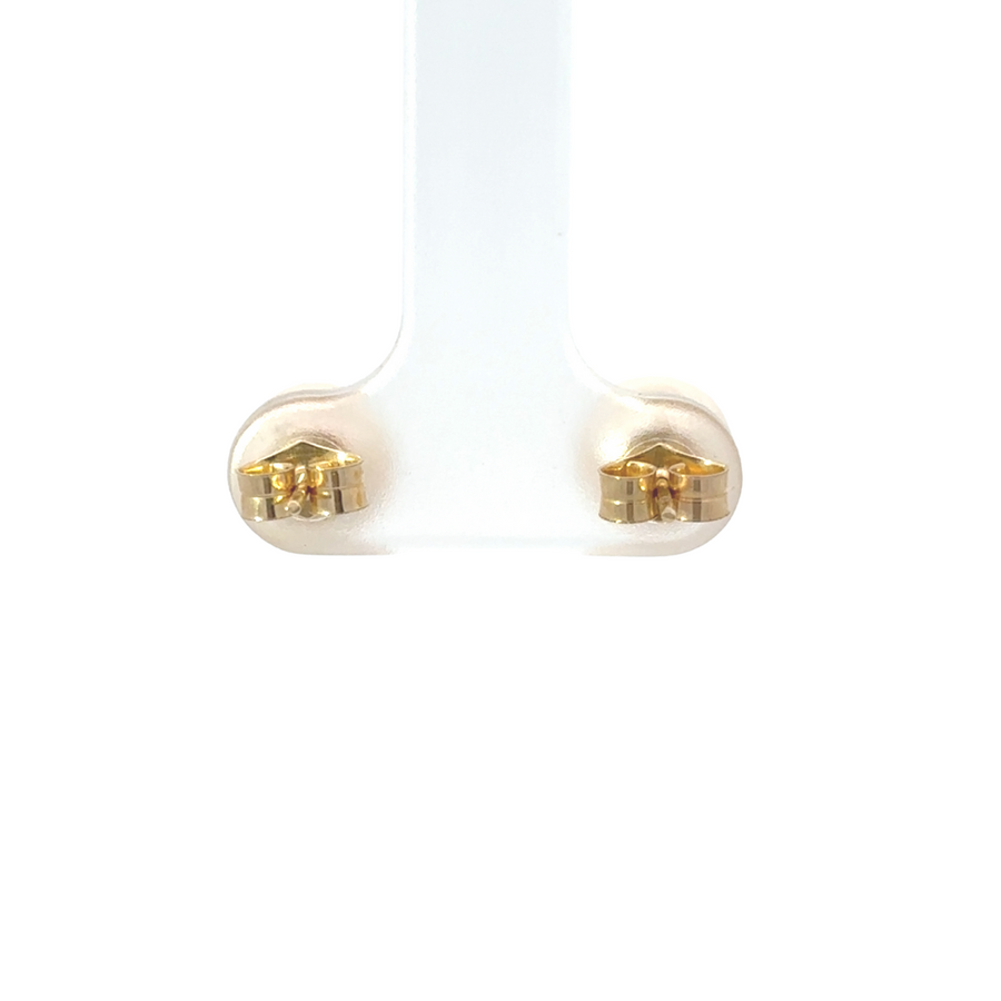 Beautiful pearl stud earrings on a velvet tray, showcasing their lustrous glow