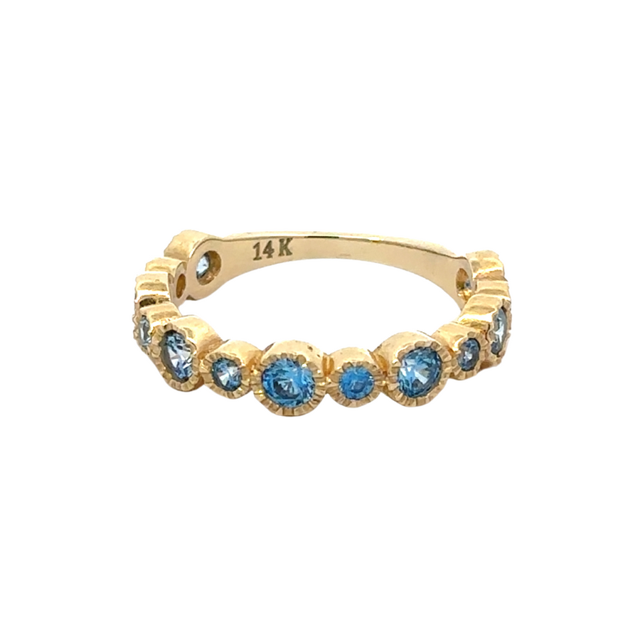 Close-up of 14K gold ring with circular blue CZ stone