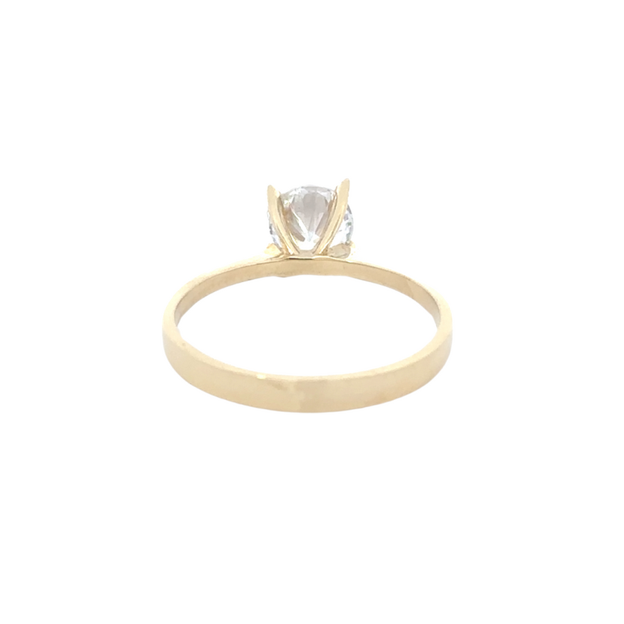 Model wearing 14K gold solitaire ring, showcasing its versatility for stacking or wearing alone