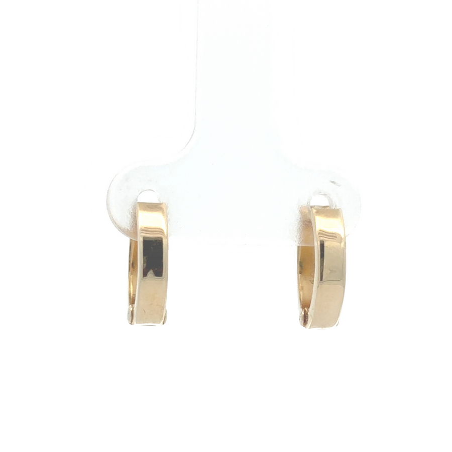 Minimalist design of 14K two-tone huggie earrings in yellow and white gold