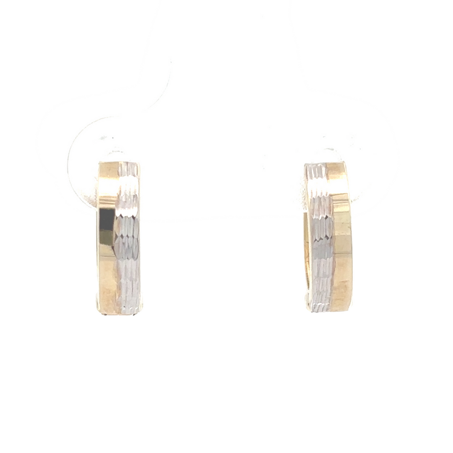 Close-up of 14K two-tone small huggie earrings in yellow and white gold