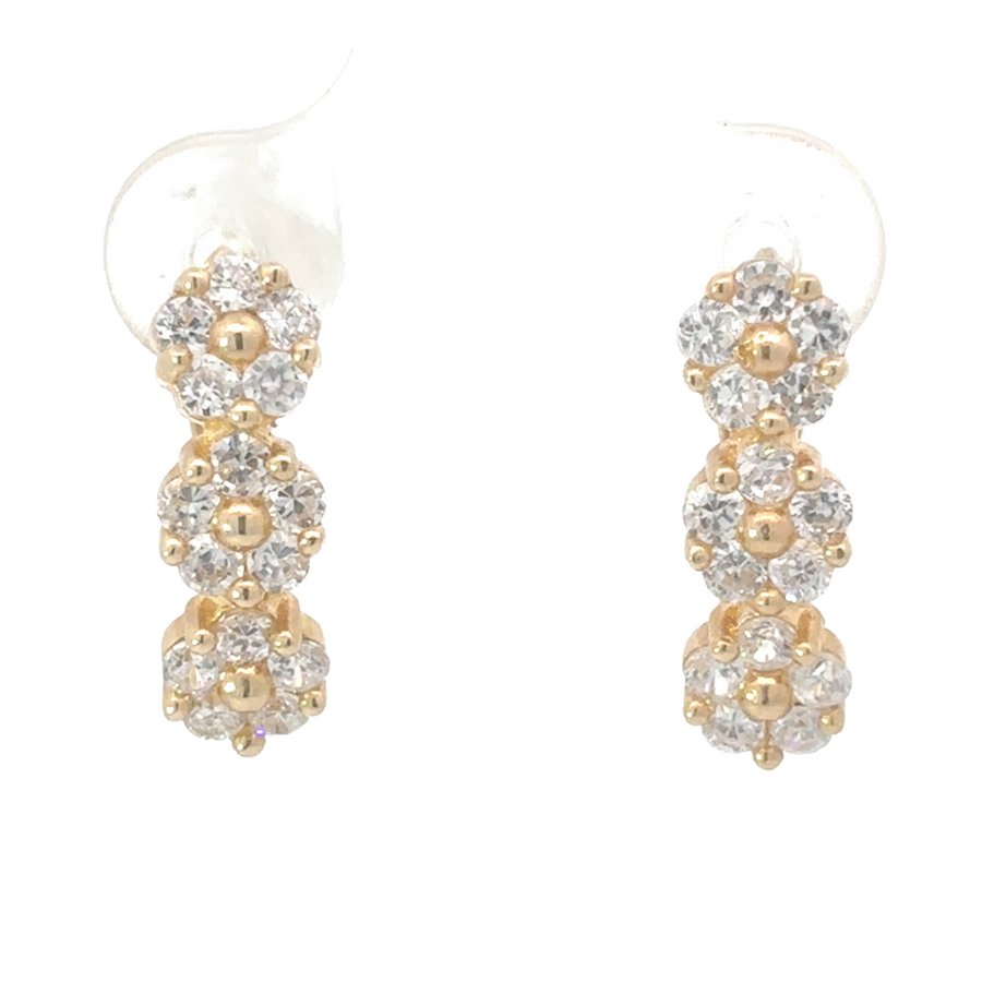 Close-up of 14K yellow gold earrings with three small flower design