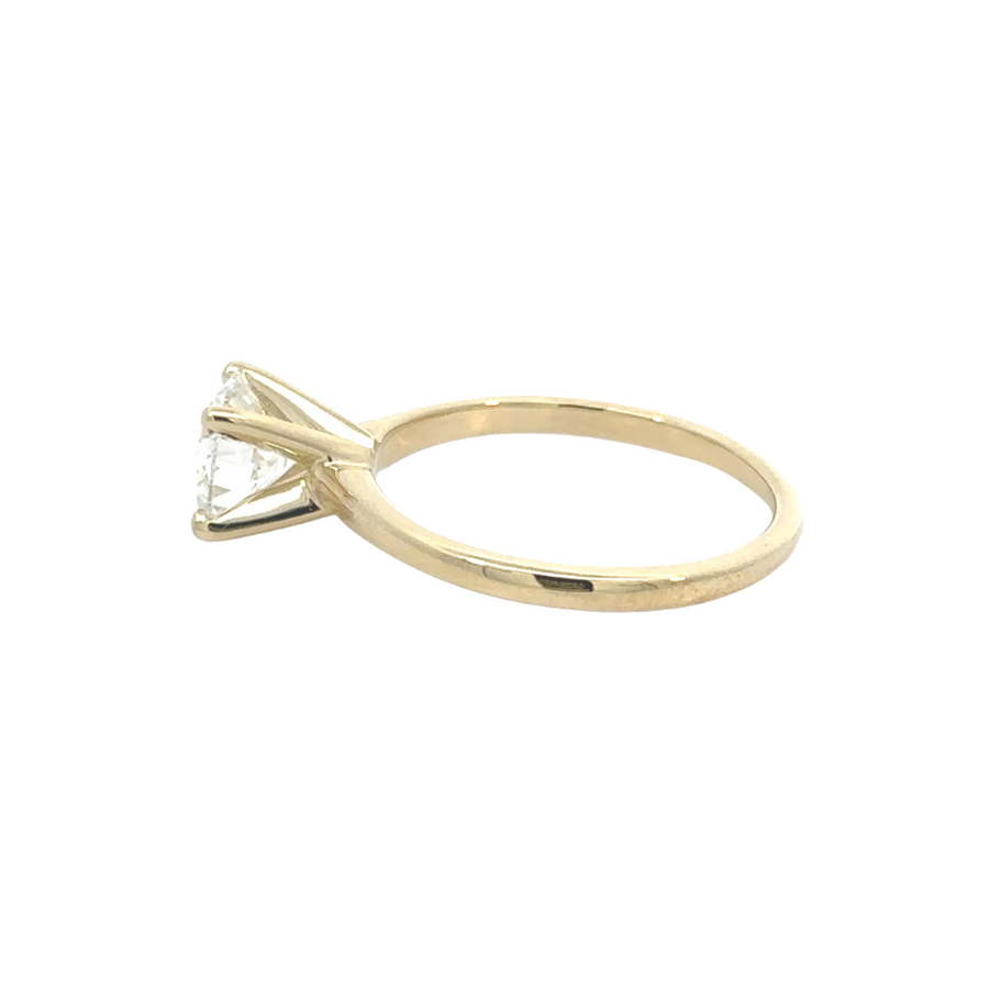 Woman’s hand wearing 14K gold ring with lab diamond, size 7