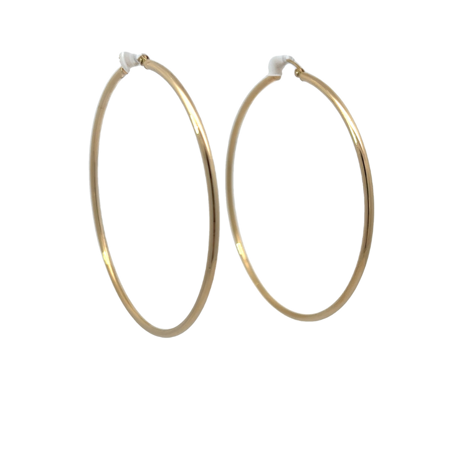 Close-up shot of the 55mm 14K gold hoop earrings showcasing their sleek design