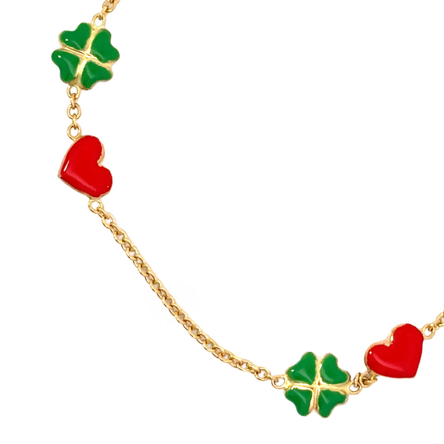 Close-up of red clover charm on 14k gold baby bracelet