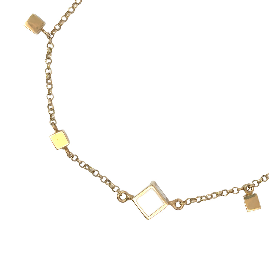 Bracelet laid flat showing geometric gold cubes and CZ