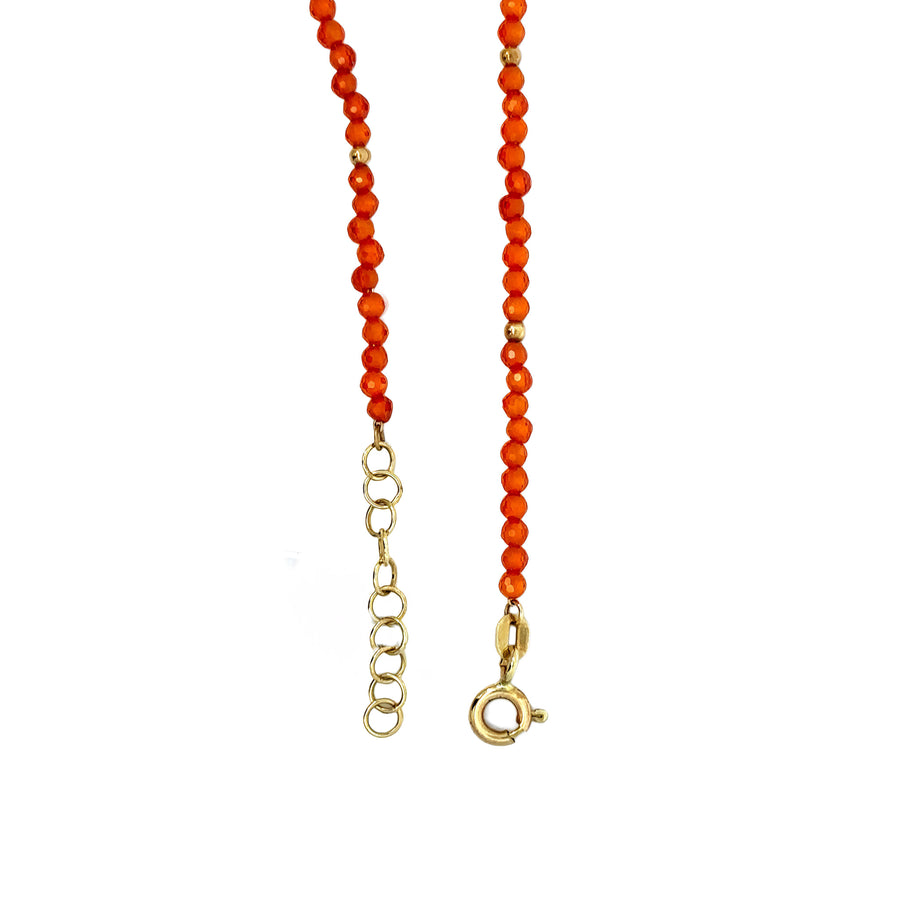 Side view of 14k gold bracelet featuring orange stone accent