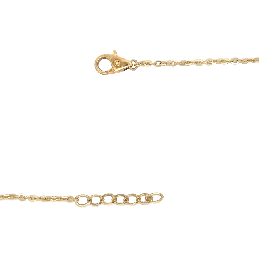 Flat-lay of 14k gold necklace on soft linen fabric