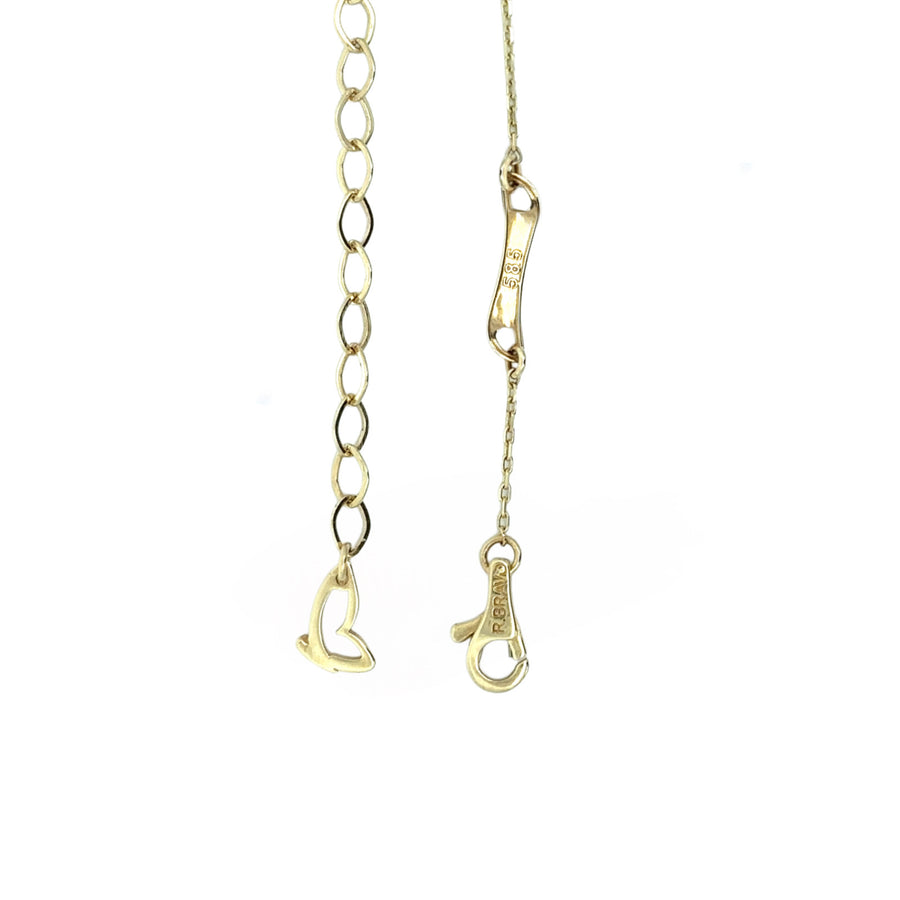 Layered styling with 14k gold adjustable necklace and other jewelry