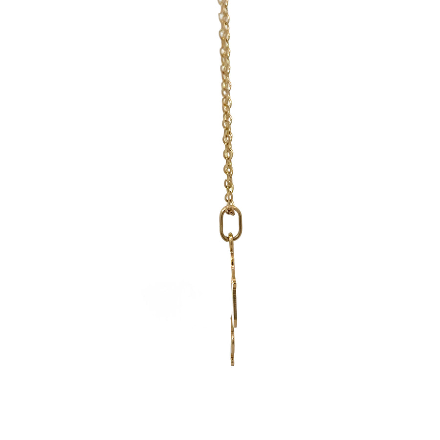 Minimalist 14k gold necklace displayed on soft fabric