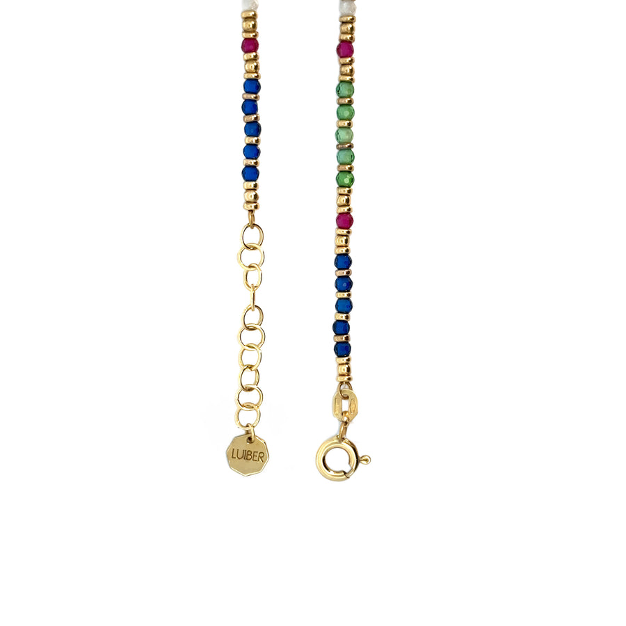 Side view of adjustable 14k gold necklace with gemstone detailing