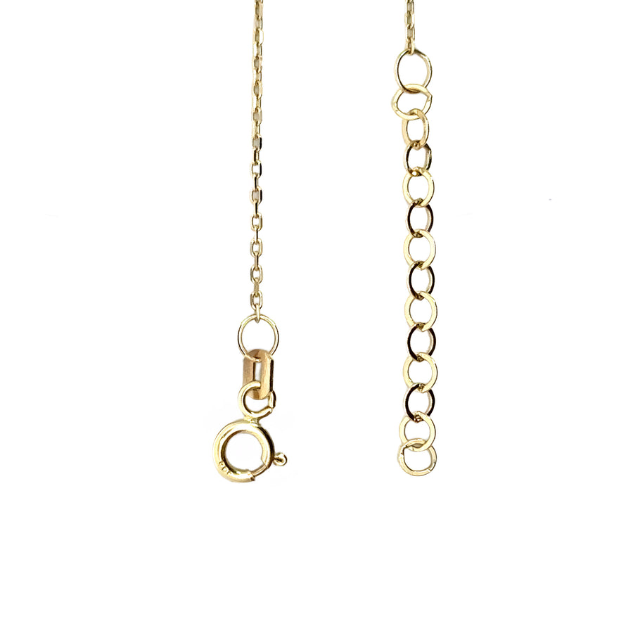 Woman wearing 14k gold anchor necklace with CZ stones