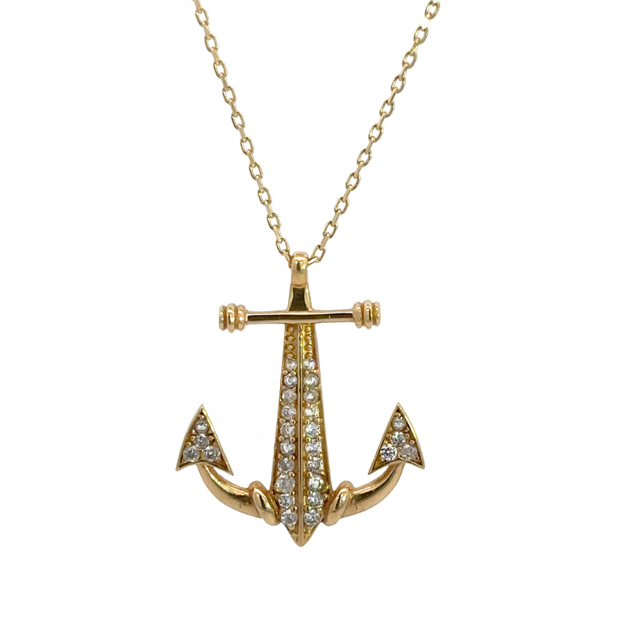 Close-up of sparkling CZ on gold anchor pendant