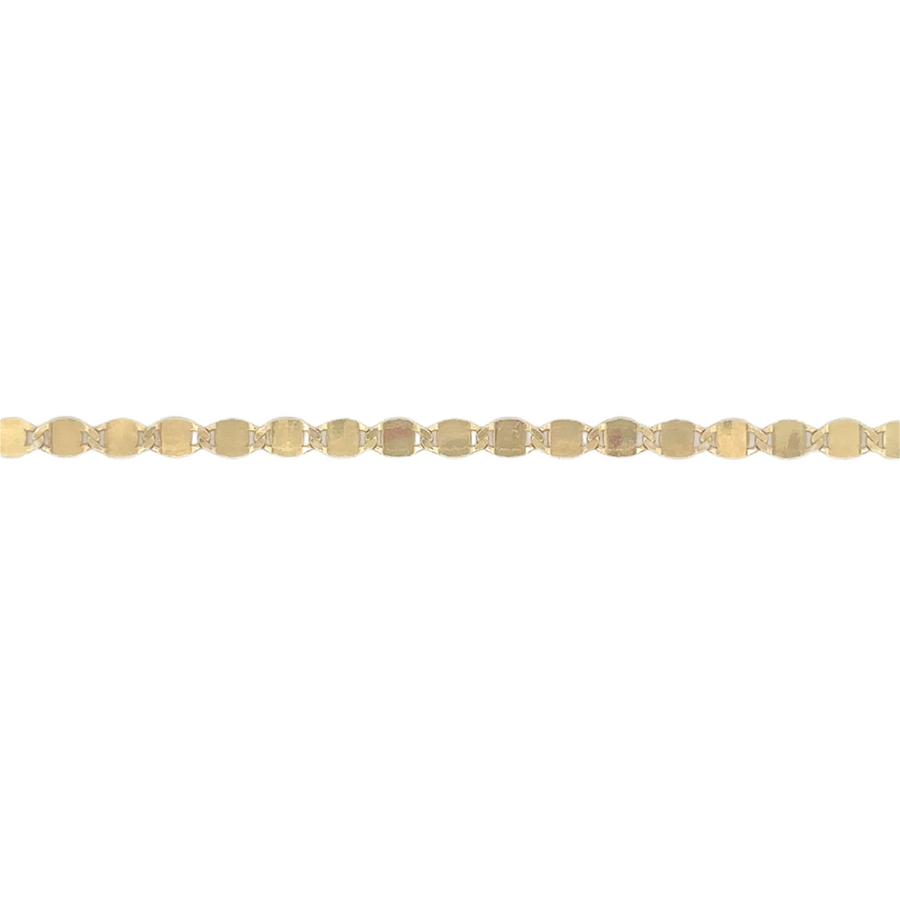 Woman wearing 14k gold ankle bracelet with elegant shimmer