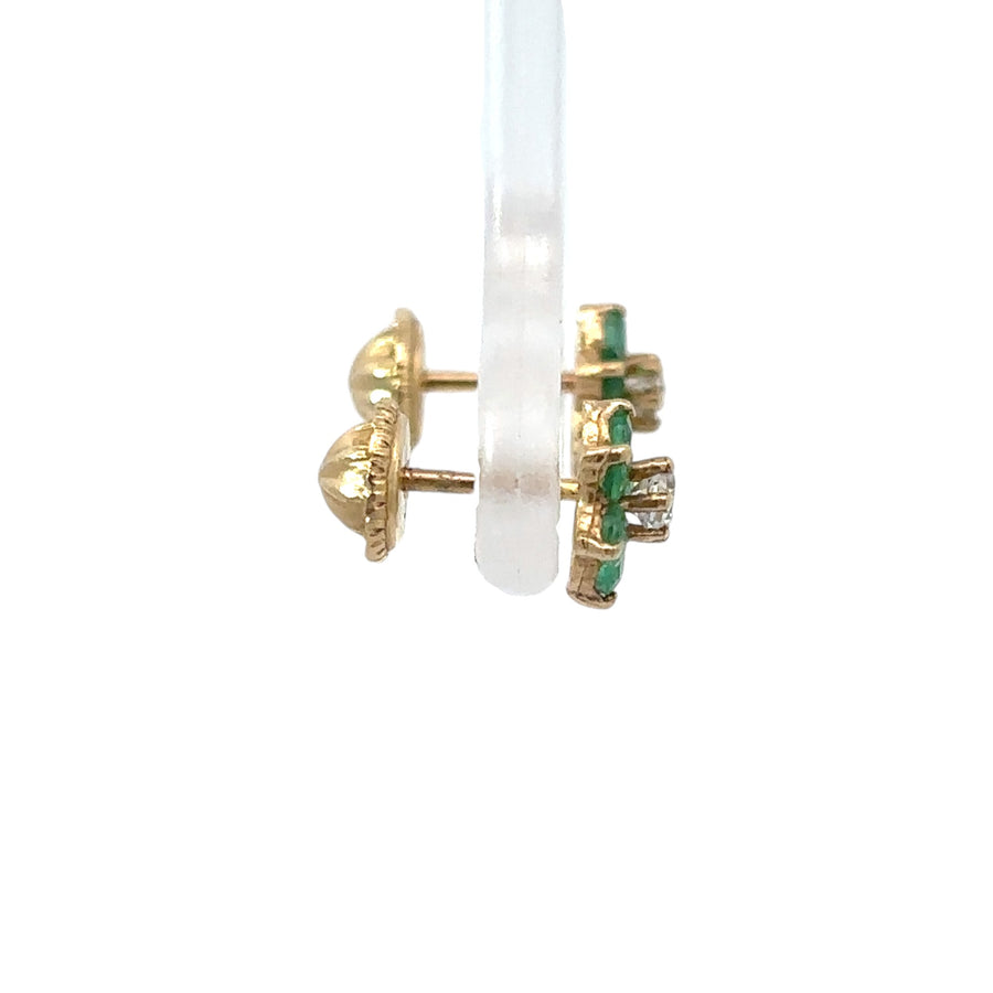 Close-up of floral baby earrings in 14k gold