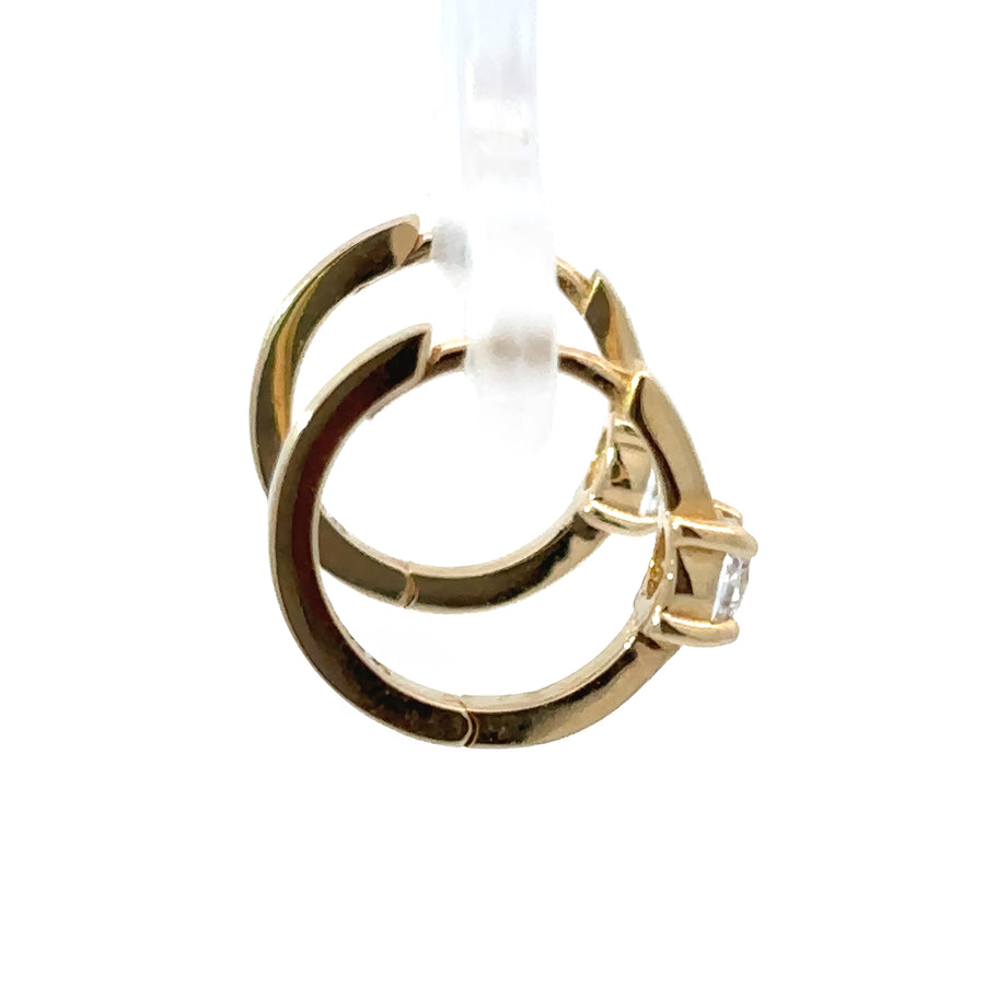 Pair of gold baby earrings featuring center stone