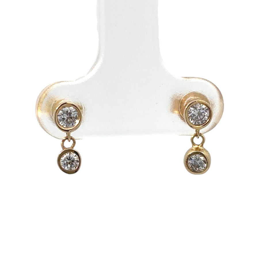 Close-up of baby stud earrings featuring cubic zirconia