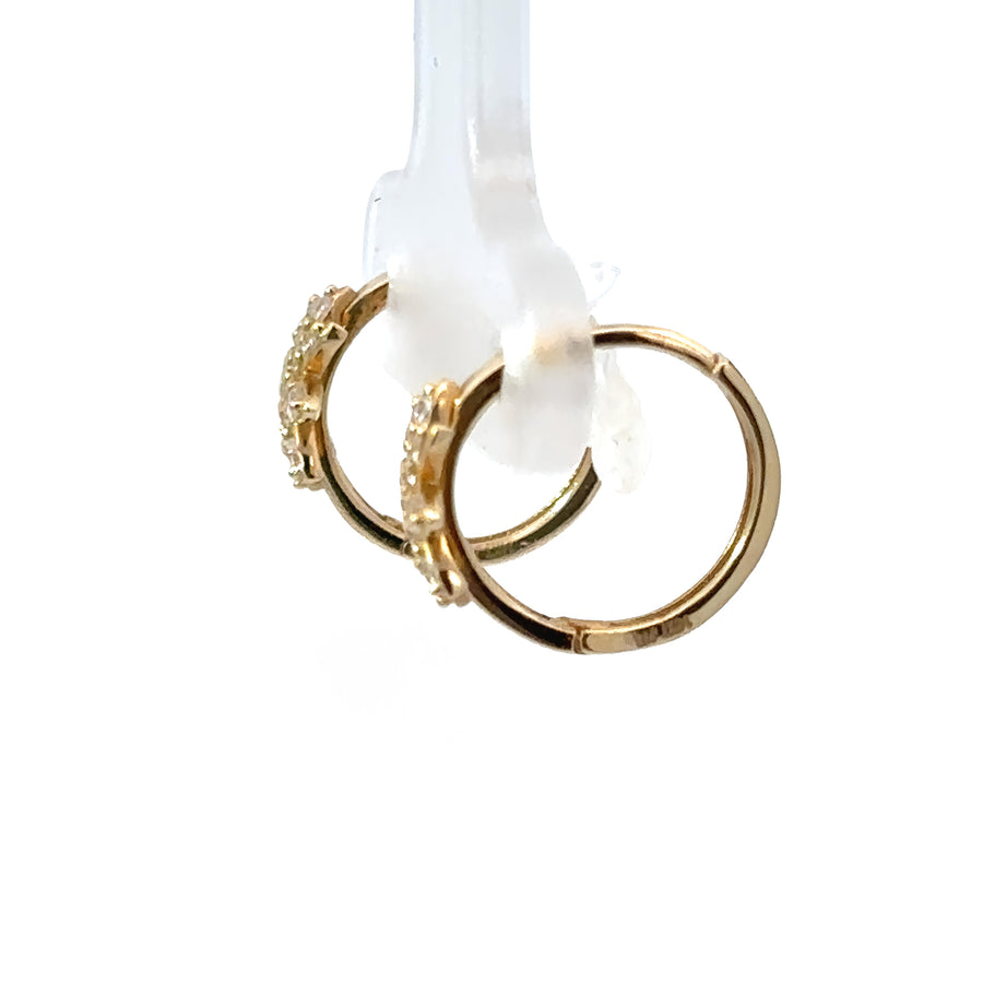 Close-up of baby earrings with sparkling CZ flower design