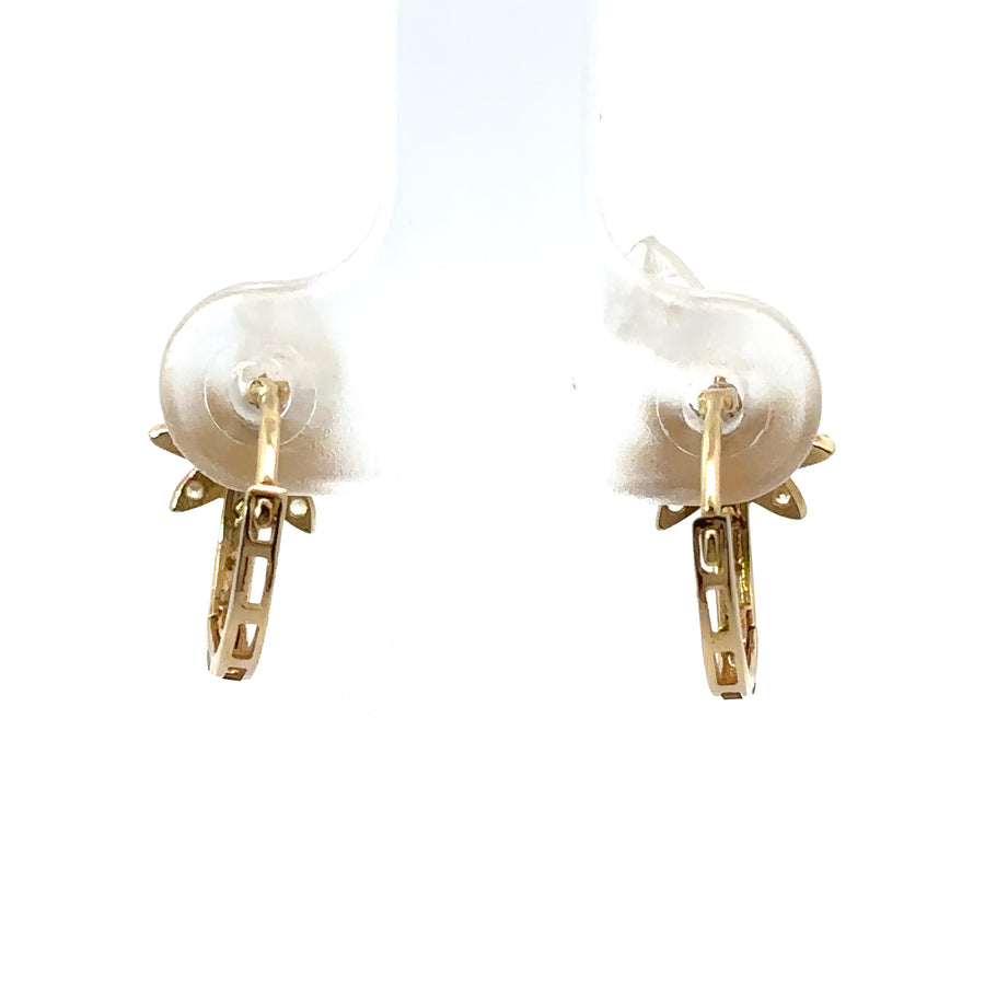 Baby wearing 14k gold flower earrings with tiny CZ accents