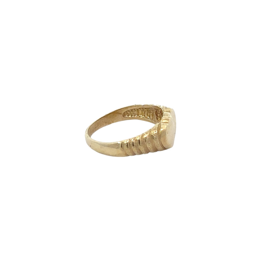 Dainty baby ring in yellow gold featuring interlocked heart design