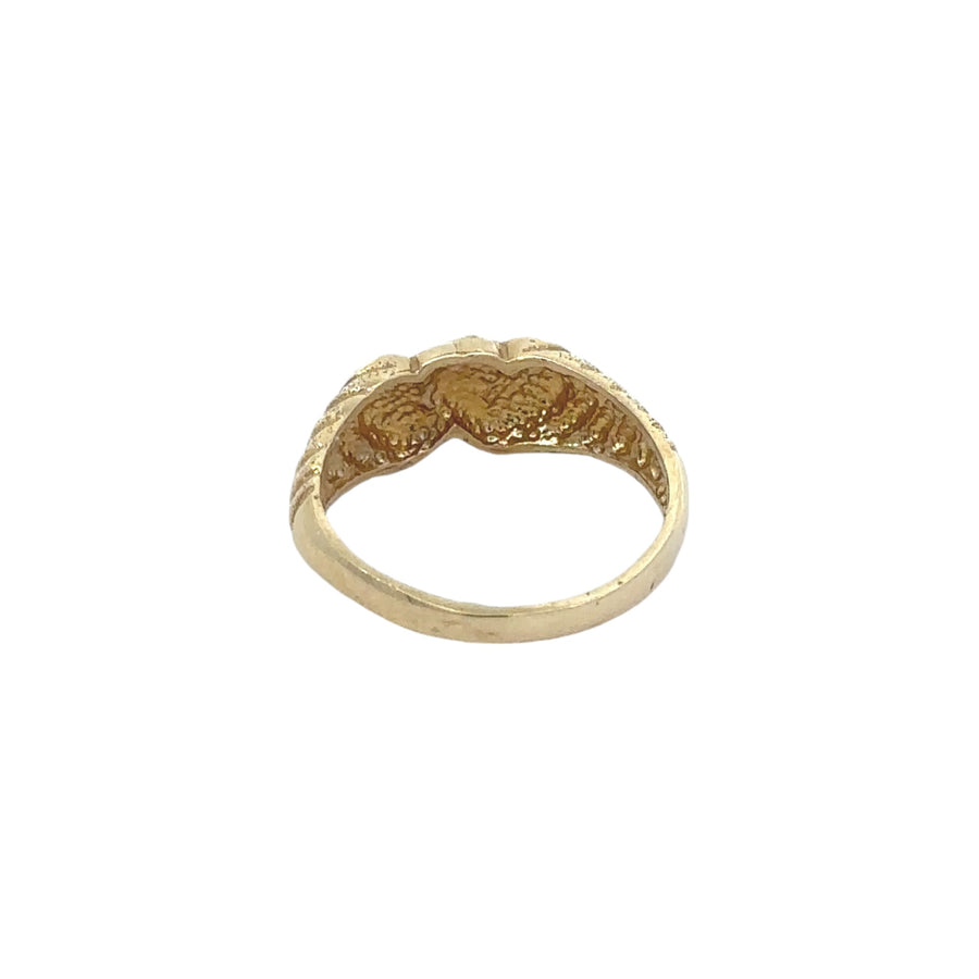 Close-up view of smooth double hearts on 14k gold ring