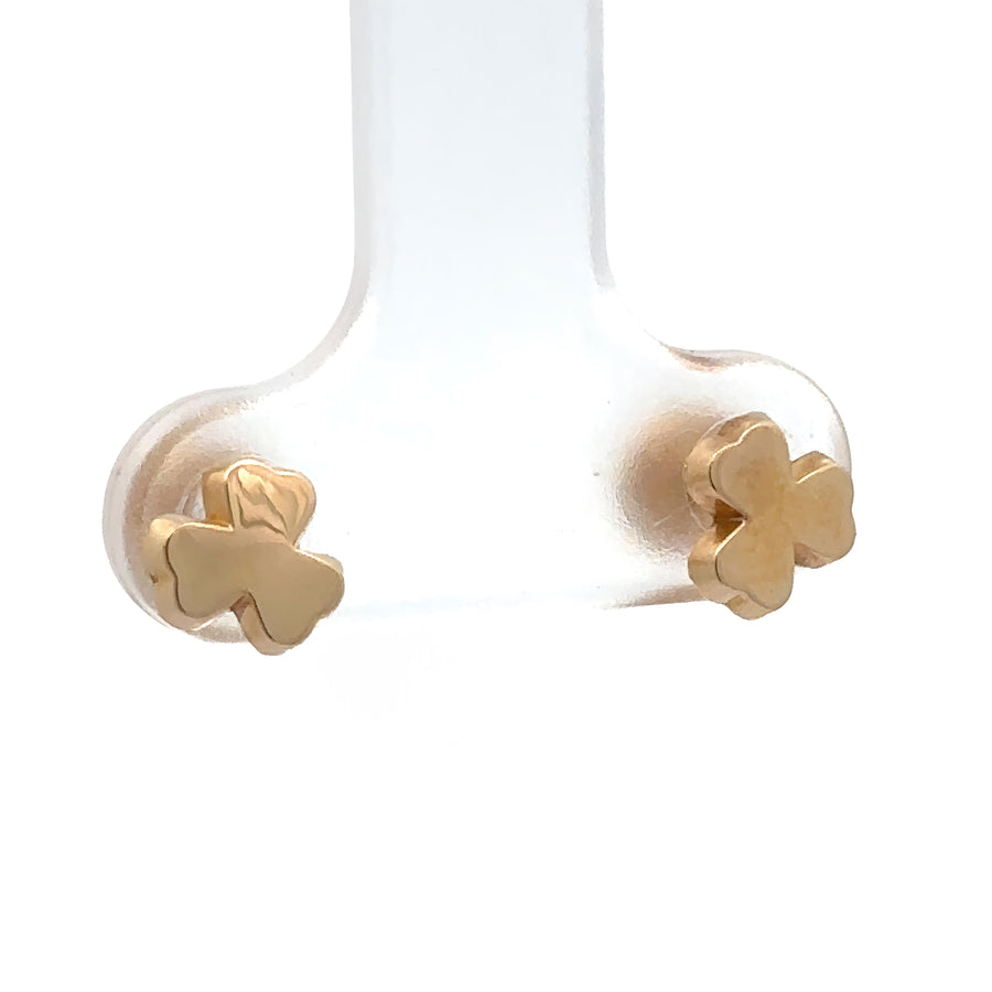 Close-up of extra small solid bow stud earrings in gold