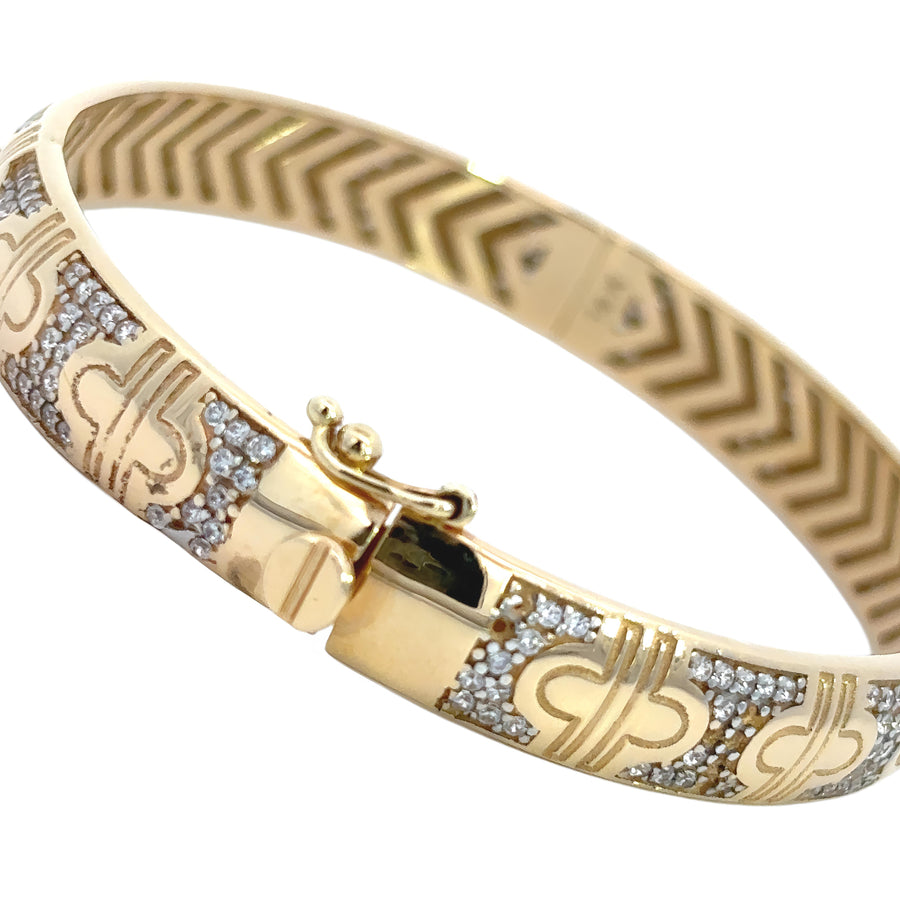 Polished 14k gold bangle displayed alone

