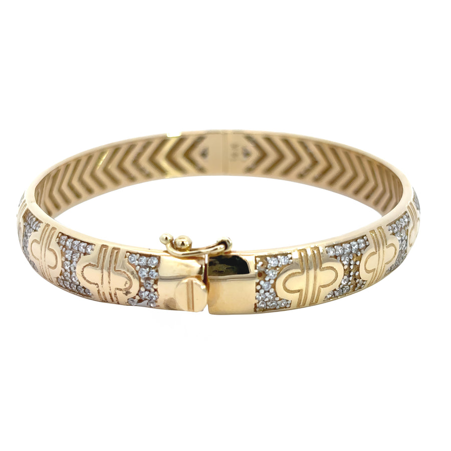 Close-up of sleek 14k gold bangle on white background