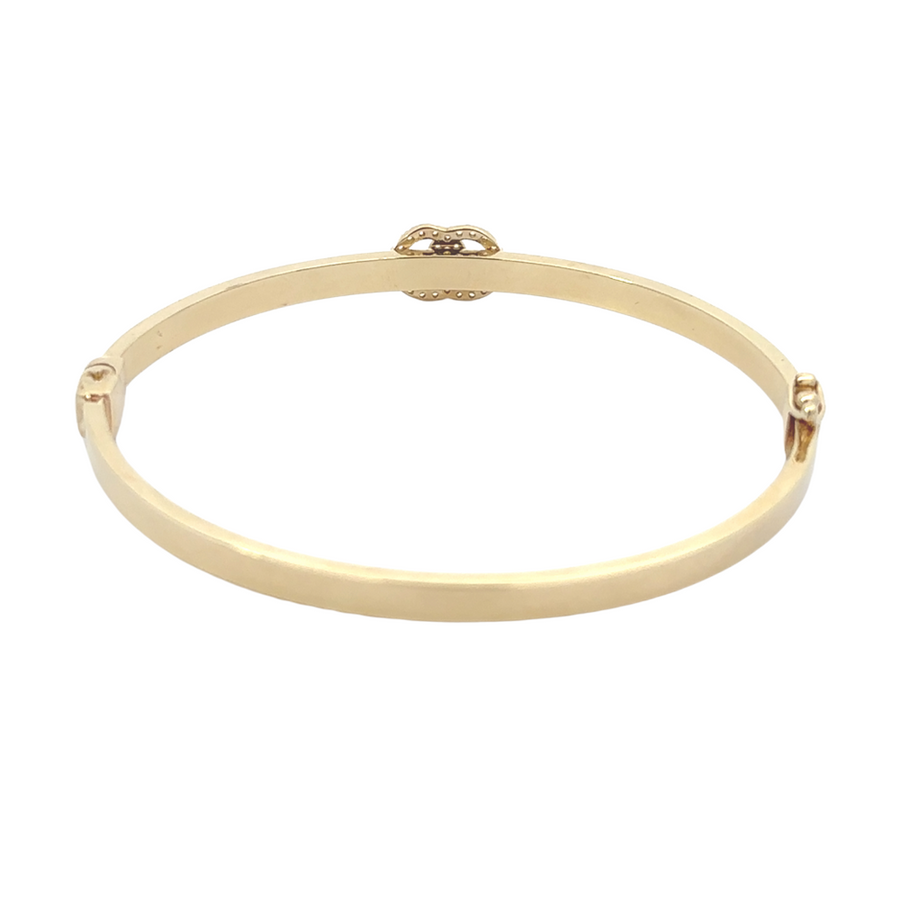 Close-up of 14k gold bangle showing smooth, polished finish