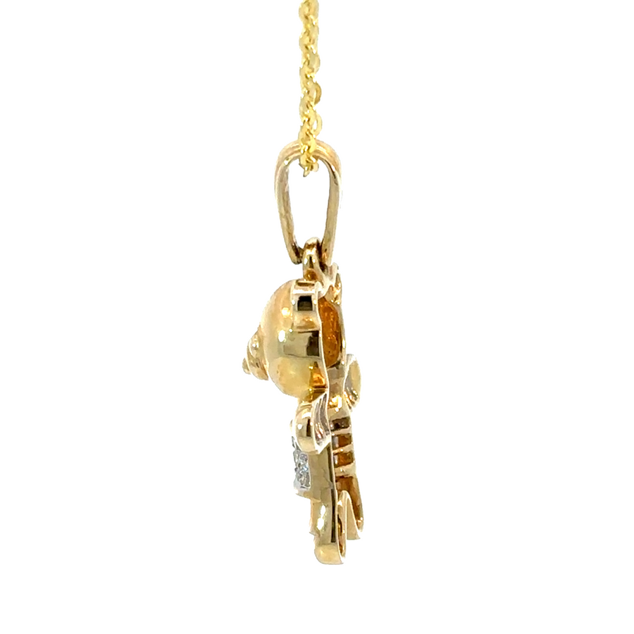 Close-up of diamond-studded bear pendant in 14k gold