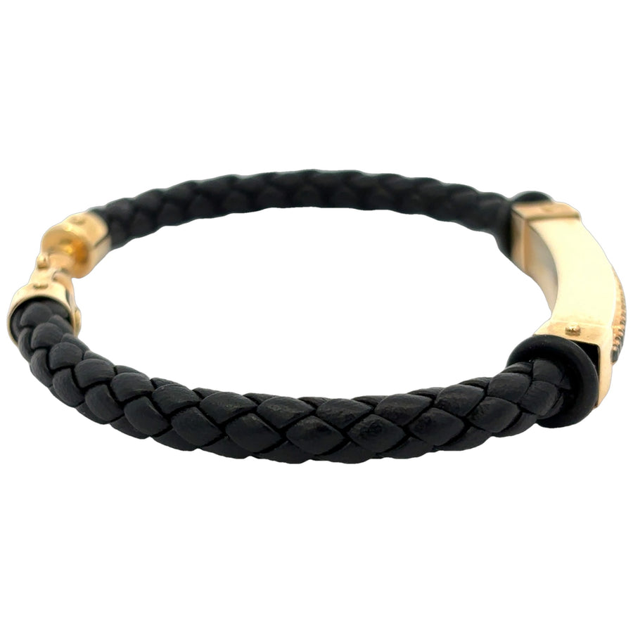 Close-up of bracelet with black leather and gold accents