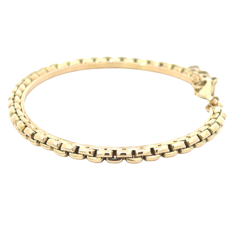 Detailed shot of the 14k gold bracelet, highlighting its smooth, polished finish.