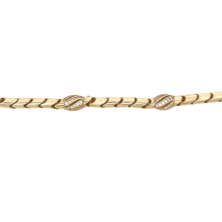 Close-up of polished 14k gold bracelet clasp and links