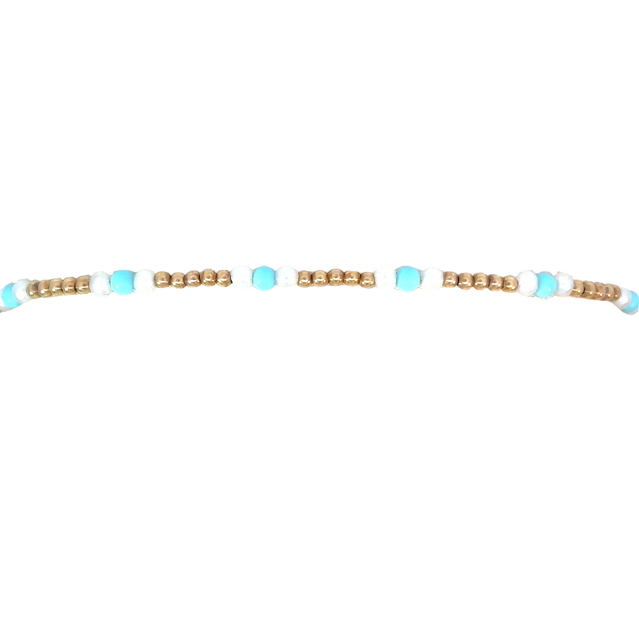 14k gold bracelet featuring pearl and turquoise displayed in a soft jewelry box