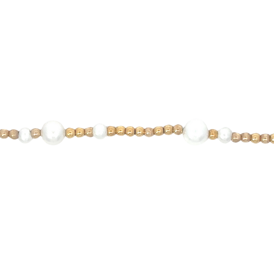 Close-up of pearl centerpiece in 14k gold bracelet