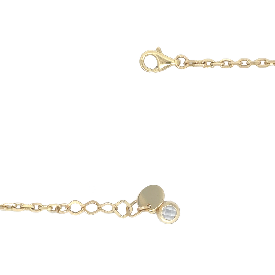 14k gold bracelet stacked with other bracelets, ideal for a layered look.
