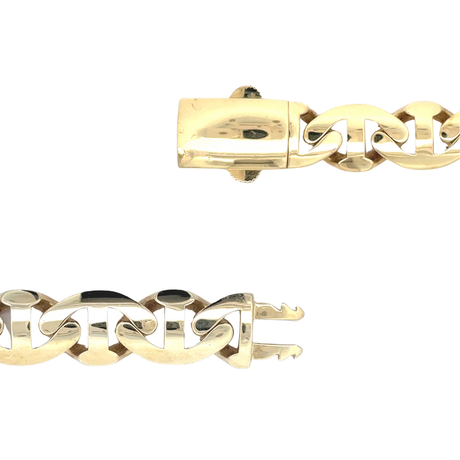 Gold bracelet displayed on a dark leather surface