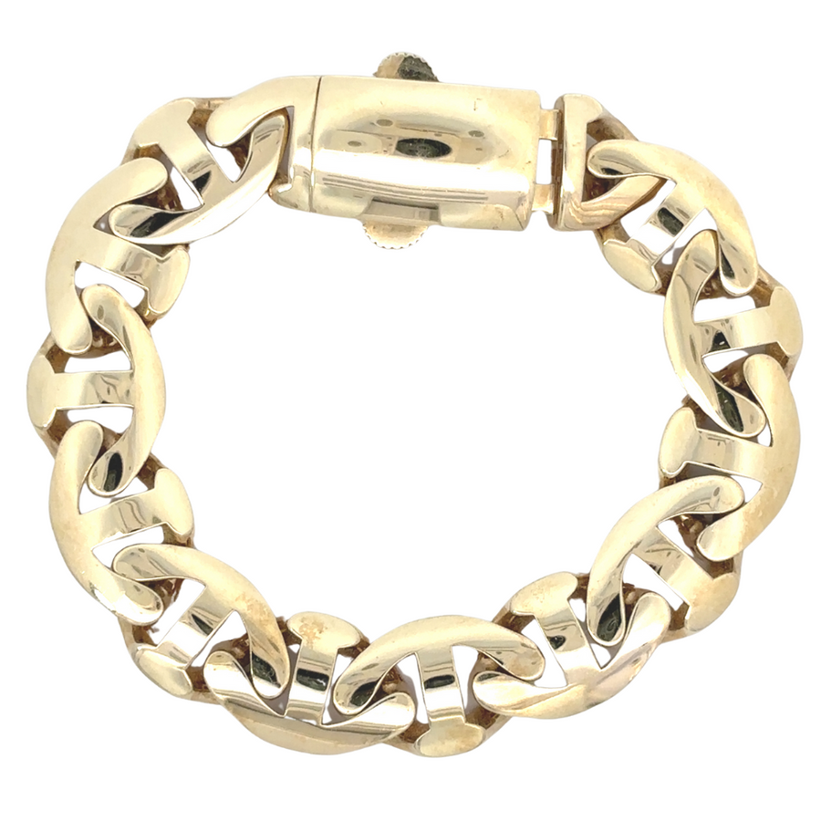 Man wearing sleek gold bracelet with a smart-casual outfit