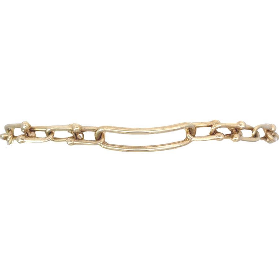 Close-up of men’s solid 14k gold bracelet with polished finish