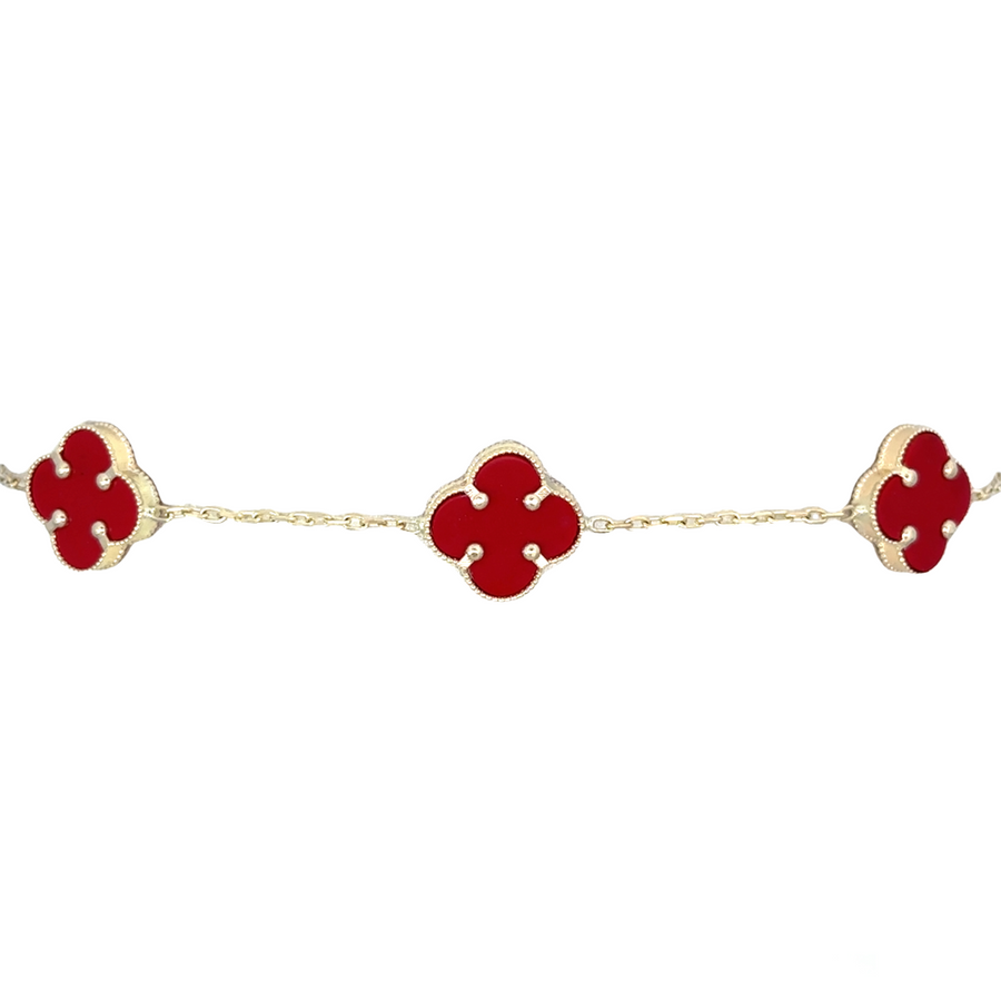 Side view of adjustable gold bracelet featuring five red details