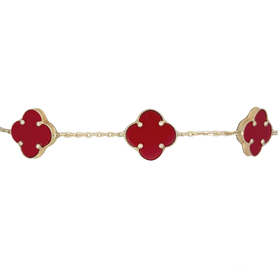 Woman wearing 14k gold bracelet with subtle red highlights