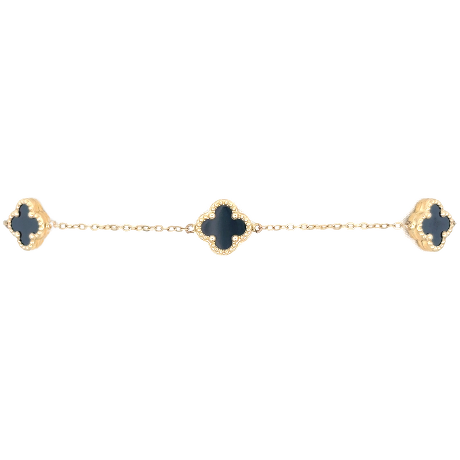 Side view of 14k gold bracelet with 5 XXS black stones highlighting its luxurious gold finish