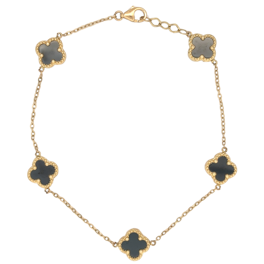 14k gold bracelet with 5 XXS black stones displayed on a dark velvet background
