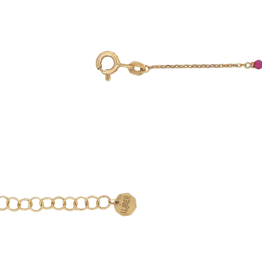 Adjustable pearl bracelet in 14k gold displayed on velvet